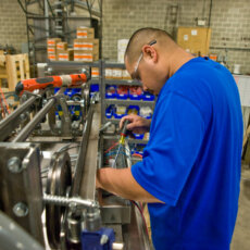 A Matot shop worker closely inspects a piece of a dumbwaiter during the manufacturing process.